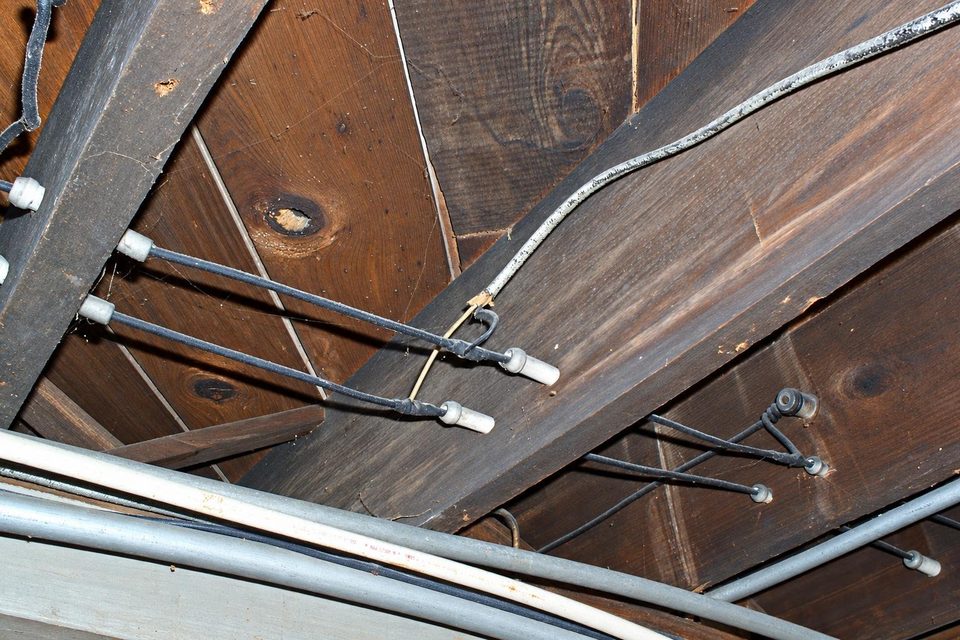 Knob-and-tube wiring on the joists of an old house.