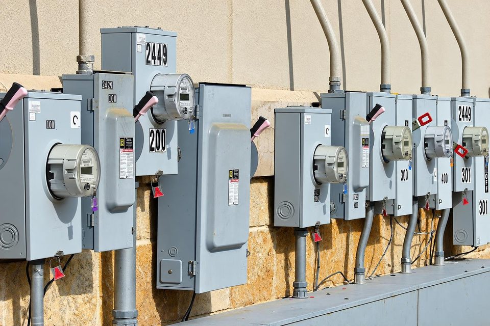 Electrical meters on the side of a commercial building.