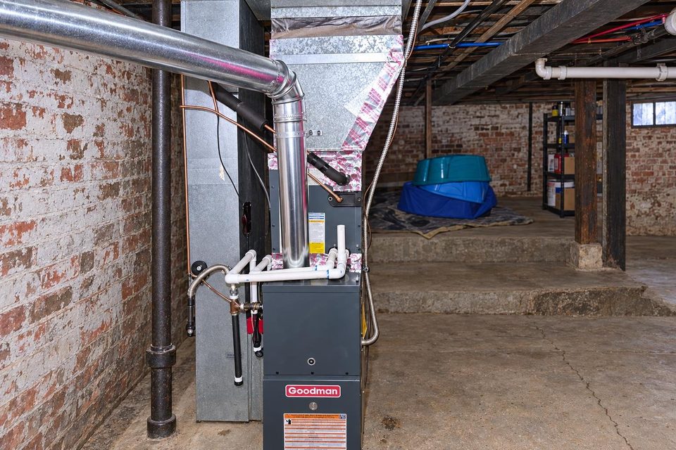 Furnace work in a home mechanical room.